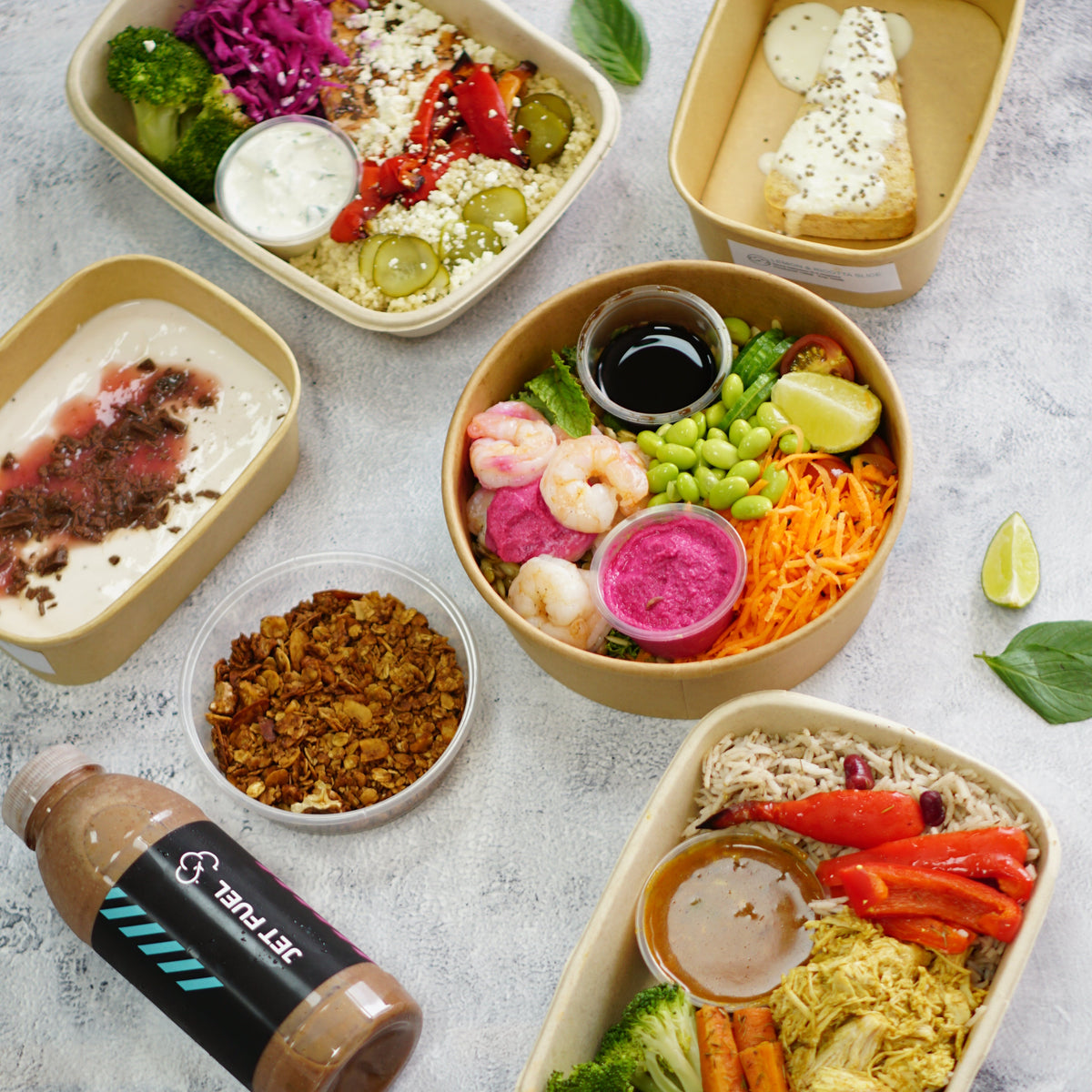 Assorted food containers with a protein smoothie. Jetlagged Chef meal prep plans macros.
